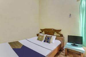 Cama o camas de una habitación en OYO Homes 91151 Desa Wisata Kreatif Perdamaian Srumbung Gunung