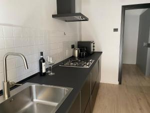 a kitchen with a sink and a stove top oven at duo apartment in Salerno