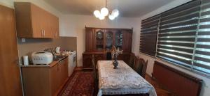 a kitchen with a table with a vase on it at Apartman Nina in Visoko