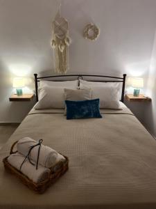 a bedroom with a large bed with two towels on it at Olivar Suites in Palekastron