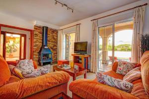 a living room with two couches and a fireplace at Villa Reyes in Nerja
