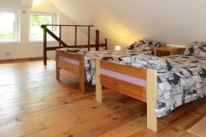 1 dormitorio con 2 camas y suelo de madera en holiday home, Wilimy en Wilimy