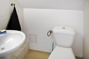 a bathroom with a white toilet and a sink at holiday home, Wilimy in Wilimy