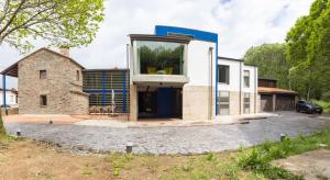 a house with a large window on the side of it at Casa rural en Sigüeiro, Santiago de Compostela in Sigüeiro