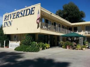 un hotel con una bandera americana delante de él en Colusa Riverside Inn, en Colusa