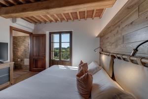 a bedroom with a large bed and a television at Terra Antica - Resort, Winery & SPA in Montepulciano +106 photos
