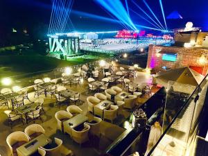 a view of a restaurant with tables and chairs at night at Pyramids Valley Boutique Hotel in Cairo