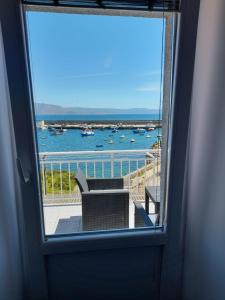 a view of a balcony with a view of the water at Apartamento vista al Puerto de Finisterre in Fisterra