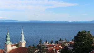 a view of a city with the ocean in the background at Apartments Komel II in Opatija
