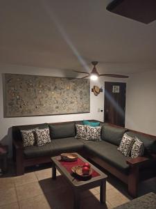 a living room with a green couch and a table at departamento de lujo, Puerto Vallarta. Mexico in Puerto Vallarta