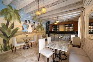 a restaurant with a mural on the wall at Hotel Casa Canabal by Faranda Boutique in Cartagena de Indias