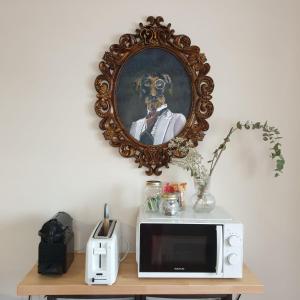 a mirror on a wall above a microwave on a table at CASAGUAPA Alto Tajo in Armallones