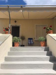 a set of stairs with potted plants on a house at LaLuzaki in Spetses