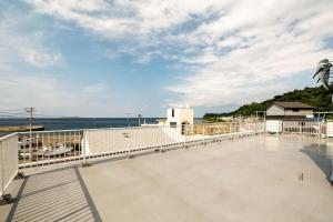 a balcony with a view of the ocean at MR. TOMO KAWANA in Kawana