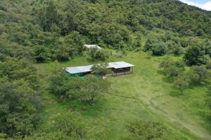 an aerial view of a house in the middle of a field at barro blanco turismo rural in Villa Achával