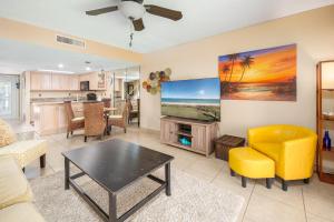 a living room with a couch and a tv at Point Matanzas B3 in St. Augustine