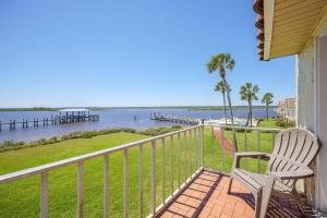 a balcony with a chair and a view of the water at Point Matanzas B3 in St. Augustine