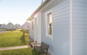 a porch with two benches next to a house at Sea You in Olpenitz