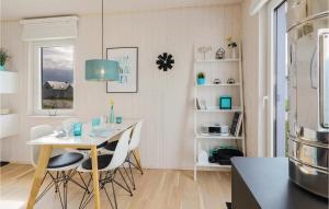 a kitchen with a table and chairs in a room at Sea You in Olpenitz +26 photos