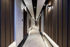 a hallway of a building with a long corridor at Hotel Hiveinn in Gwangju