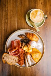 a plate of breakfast food on a wooden table at Joondalup Resort in Perth