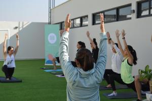 a group of people in a yoga class at NIU Modern & Centric Lofts in Mexico City