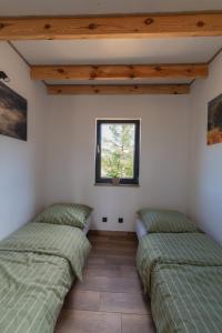 Postel nebo postele na pokoji v ubytování Widokówka Myczkowce