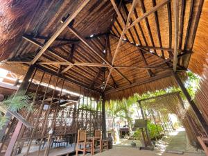 a large wooden building with tables and chairs in it at Palms Cove Resort in Panglao Island