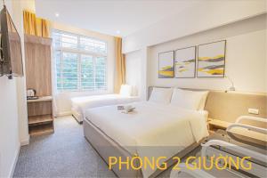 Postel nebo postele na pokoji v ubytování Keypad Hotel - 28 Dịch Vọng Hậu