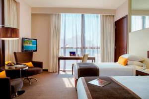a living room filled with furniture and a tv at Centro Barsha - by Rotana in Dubai