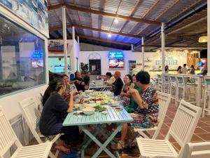a group of people sitting at a table eating food at Phan rang kite center in Ấp Mỹ Hải