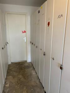 an empty locker room with white walls and a door at Studio Font-Romeu avec place de parking in Font-Romeu-Odeillo-Via