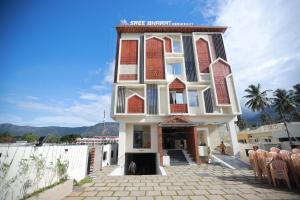 a building with chairs in front of it at Sree Bharat Residency in Alāndurai