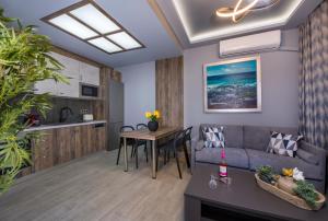a living room with a couch and a table at Rena's luxury apartment with free private parking in Chania
