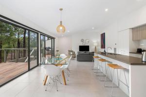 a kitchen and living room with a table and chairs at Ocean Haven in Aireys Inlet