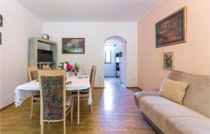 a living room with a table and a couch at Cozy Home In Grizane With Kitchen in Grižane