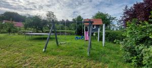 a swing set in a grassy field at Dobre Miejsce in Międzyzdroje