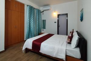 a hotel room with a bed and a closet at Jubels Homestay in Guwahati