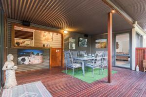 a porch with a table and chairs on a house at Balconies Dolphincove in Tura Beach