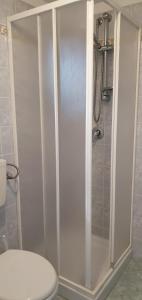a shower with a glass door in a bathroom at La casetta di Kamma in Kamma