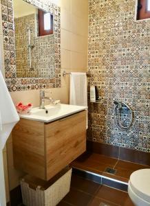 a bathroom with a sink and a shower at Anogeio - Traditional house in Tikhion in Tíkhion