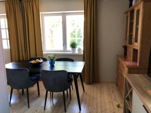 a dining room with a table and chairs and a window at Manni Homestay in Kuressaare