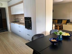a kitchen and dining room with a table and chairs at Manni Homestay in Kuressaare