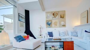 a living room with two white couches and a glass table at Villa Bonanova Style in Palma de Mallorca