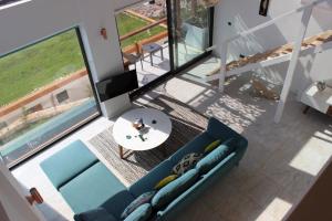 an overhead view of a living room with a blue couch at Mandalina Suites in Kaş