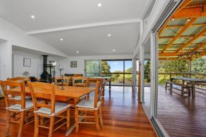 a dining room with a wooden table and chairs at Cooinda in Apollo Bay