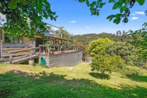 a house with a large deck in the yard at Cooinda in Apollo Bay +10 photos