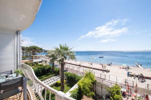 a balcony with a view of the beach at SERRENDY Renovated apartment with sea view in Cannes