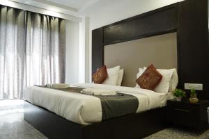 Postel nebo postele na pokoji v ubytování Hotel Anand Empire Near New Delhi Railway Station