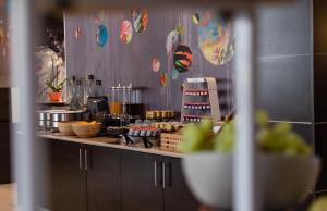 a kitchen with a counter with food on it at Novotel Brussels Centre Midi in Brussels